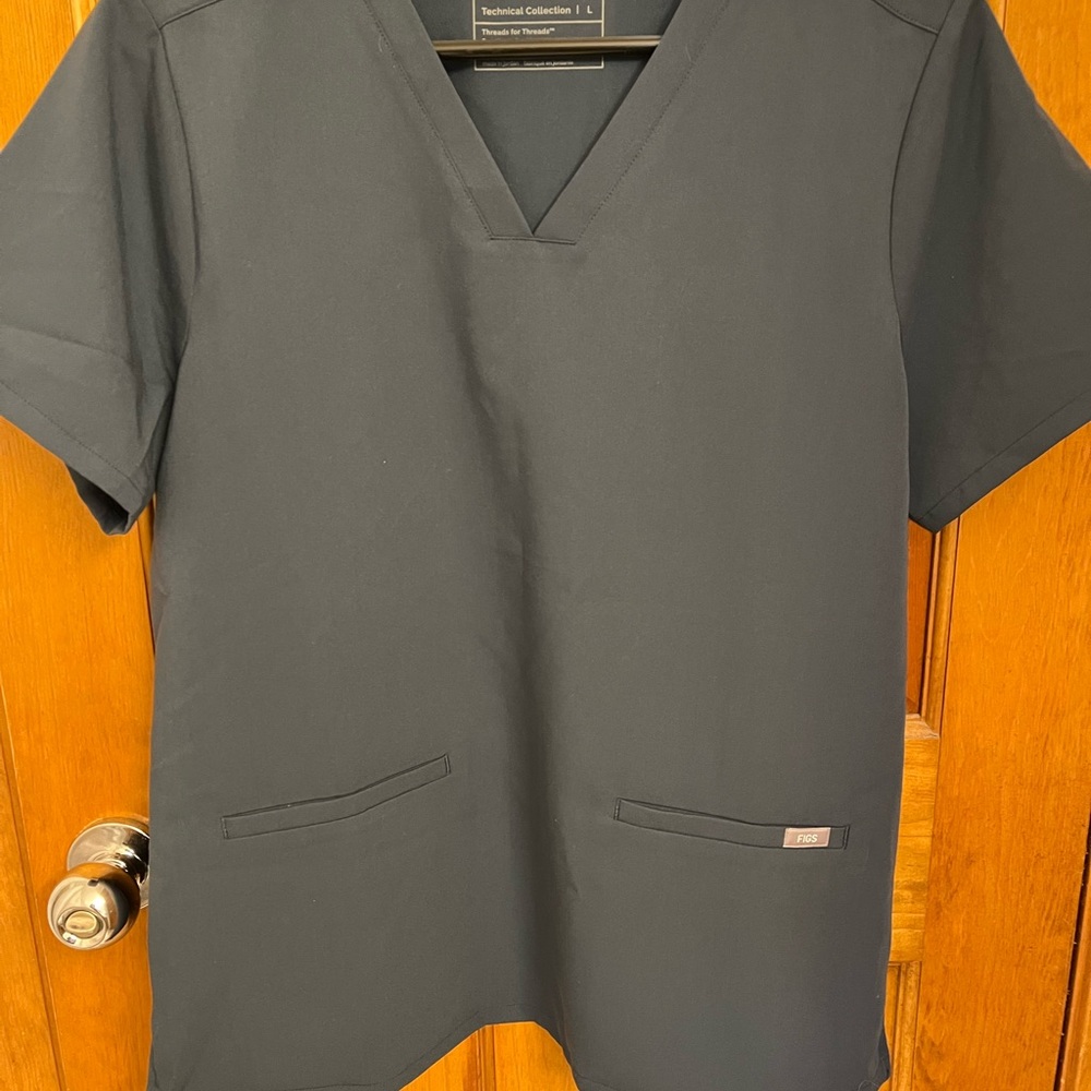 FIGS scrub top with tags attached.